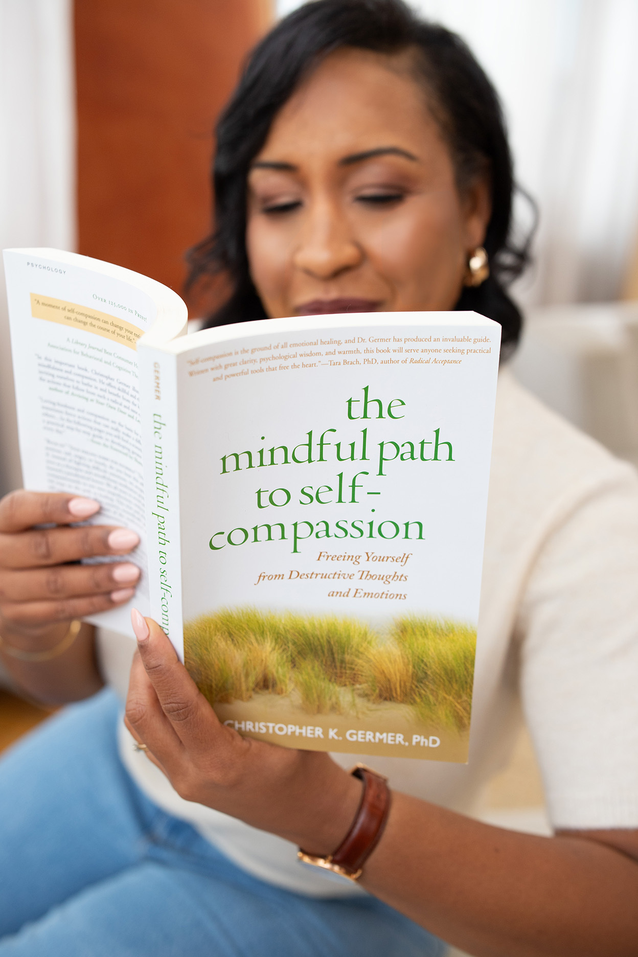 A therapist reading a book on self-compassion