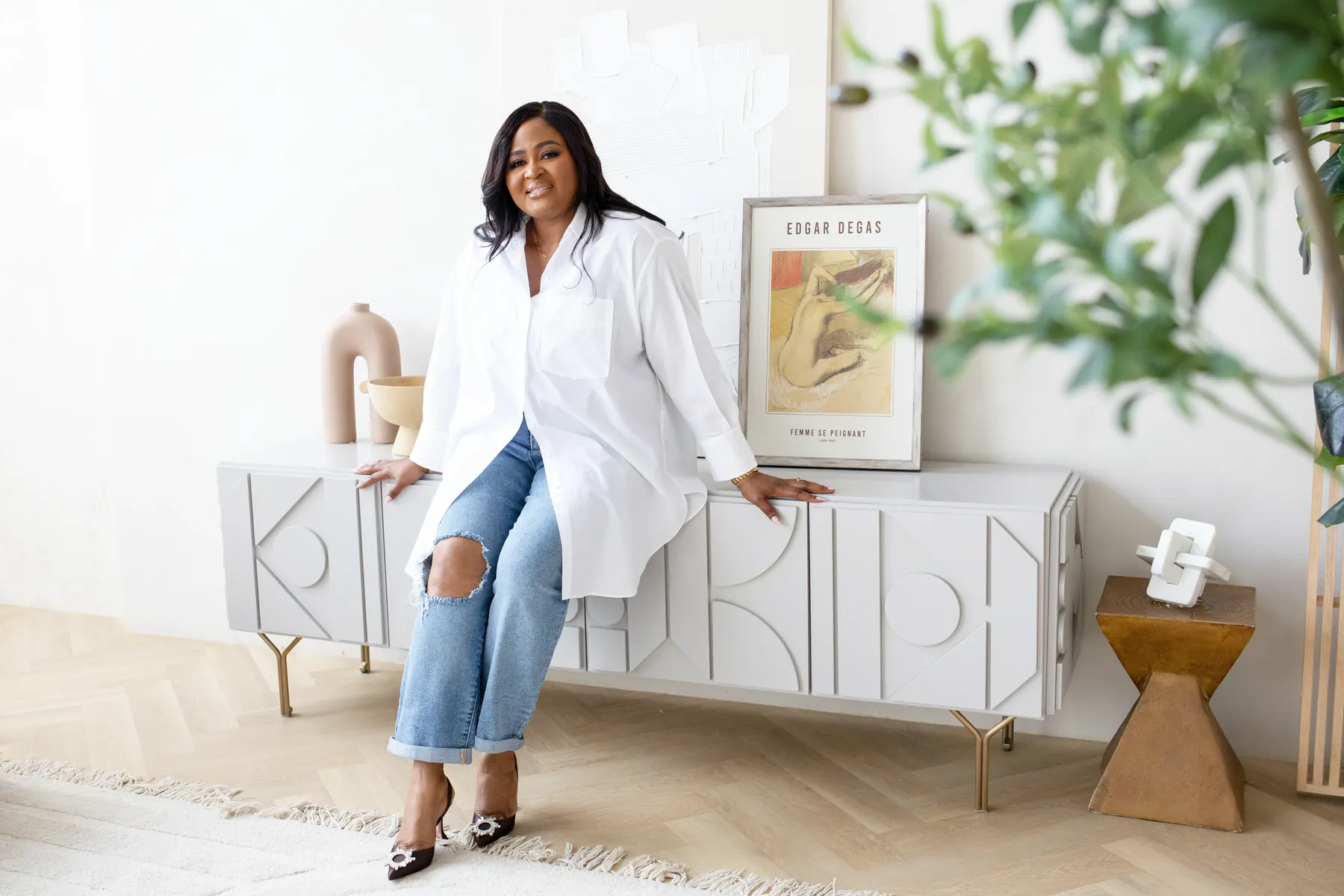 Therapist sitting on a sideboard in her space